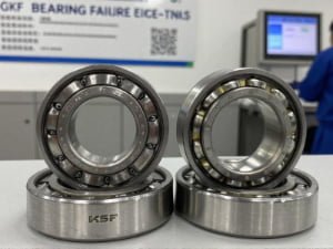 Bearing failure analysis showing spalling on counterfeit unit versus intact genuine SKF raceway